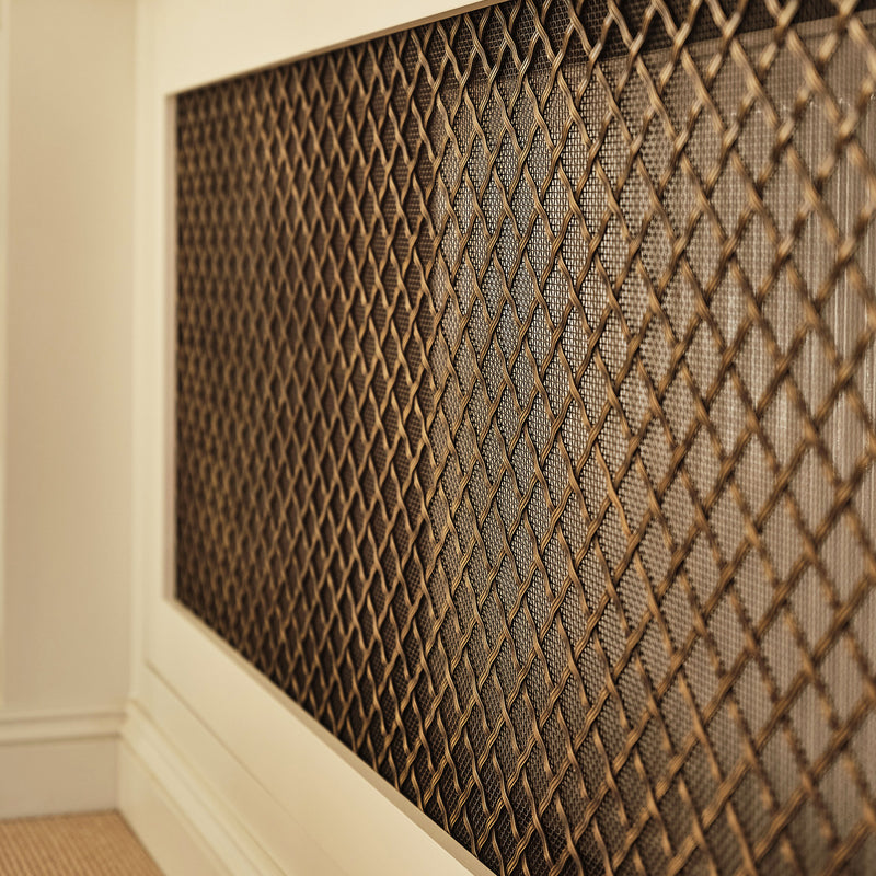 Features our 19mm Diamond Interwoven Grille with 3mm Reeded Wire and Coarse Mesh Backing in our antique brass lacquered (ABL) grille finish | Project by Laura Butler-Madden | Photography by Patrick Butler-Madden. 