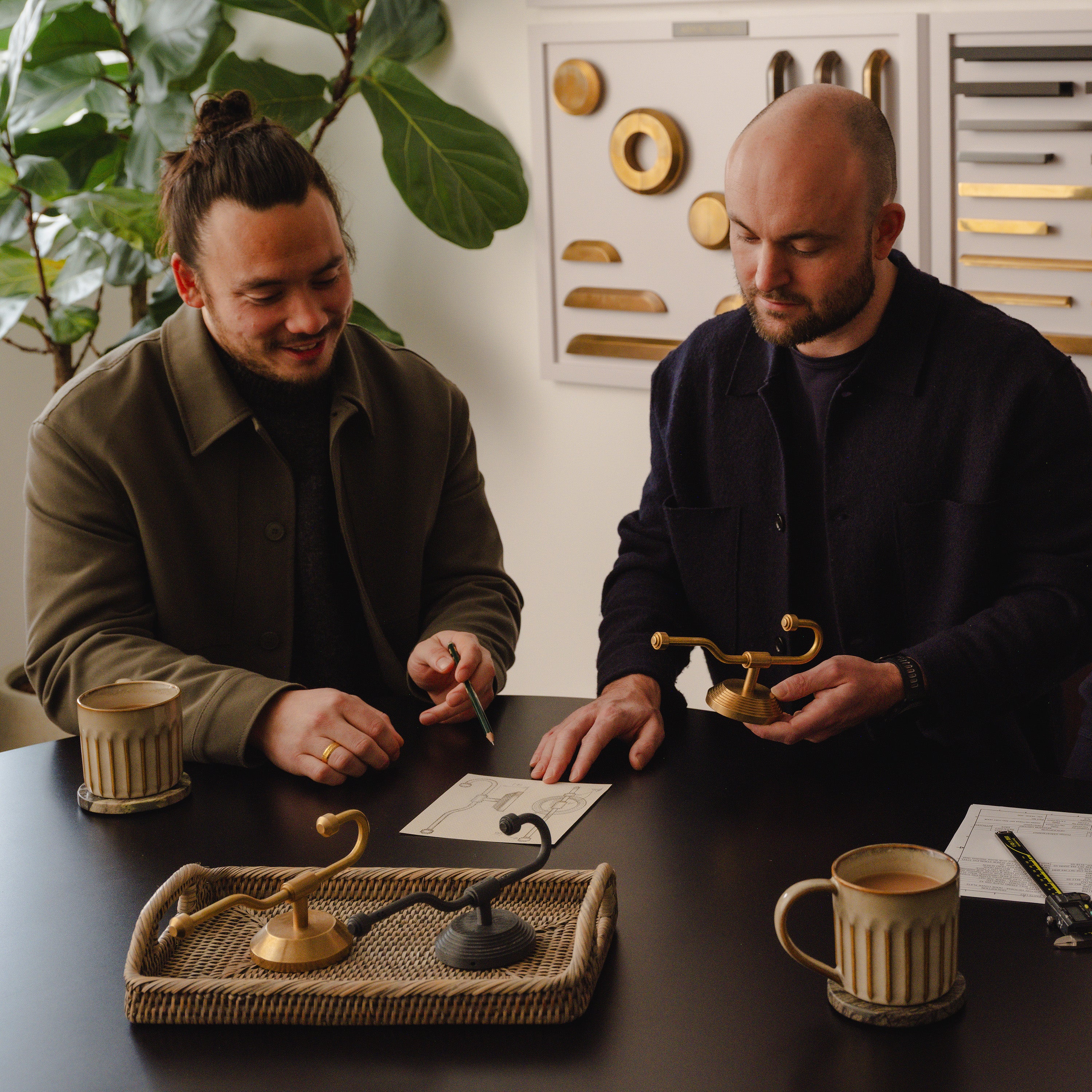 Hardware consultation with multiple brass and dark finish options laid out on a table