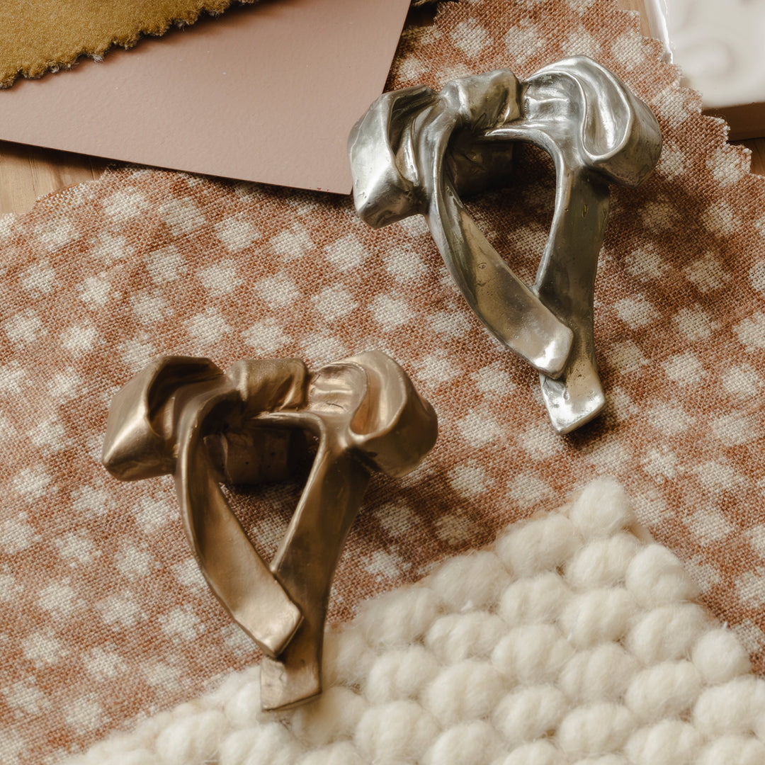 Photography by Joey Kendal Brown | Whimsical Bow Cabinet Knobs shown in burnished bronze (BR) and burnished white bronze (WB). 